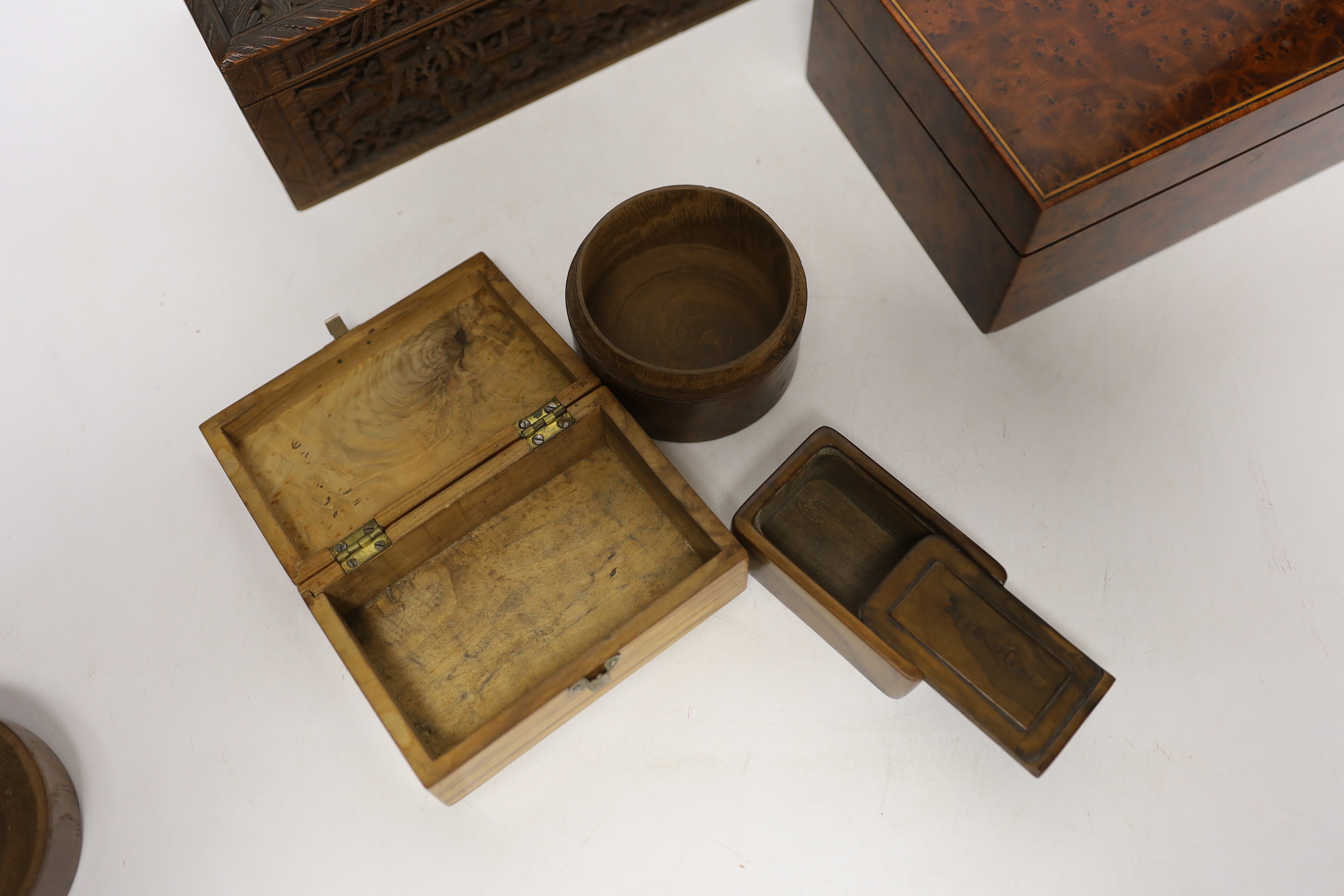 A 19th century Chinese carved boxwood box, an amboyna cigarette box and three others